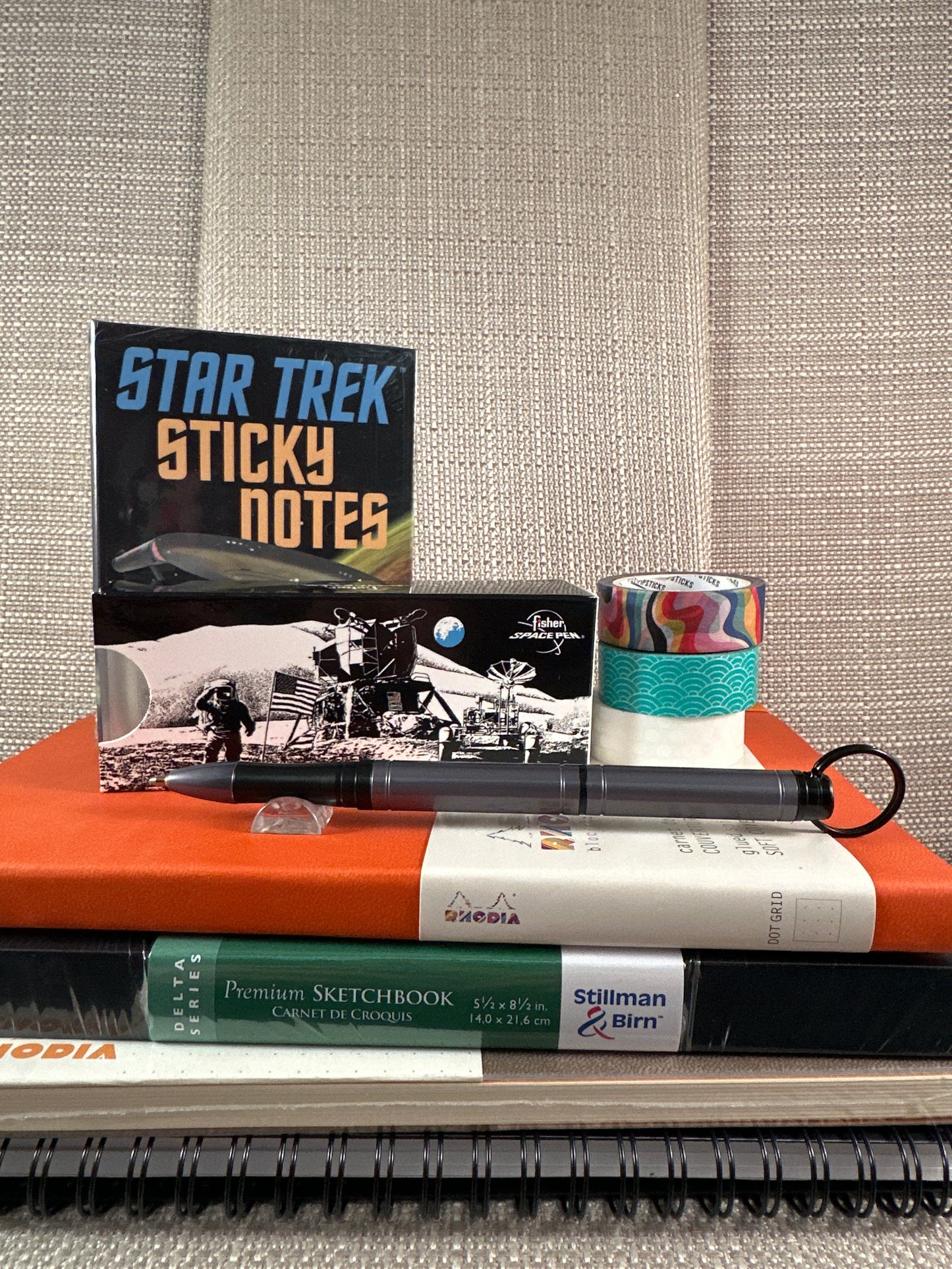 Fisher Backpacker Space Pen with Star Trek Sticky Notes and sketchbooks in a stationery store display.