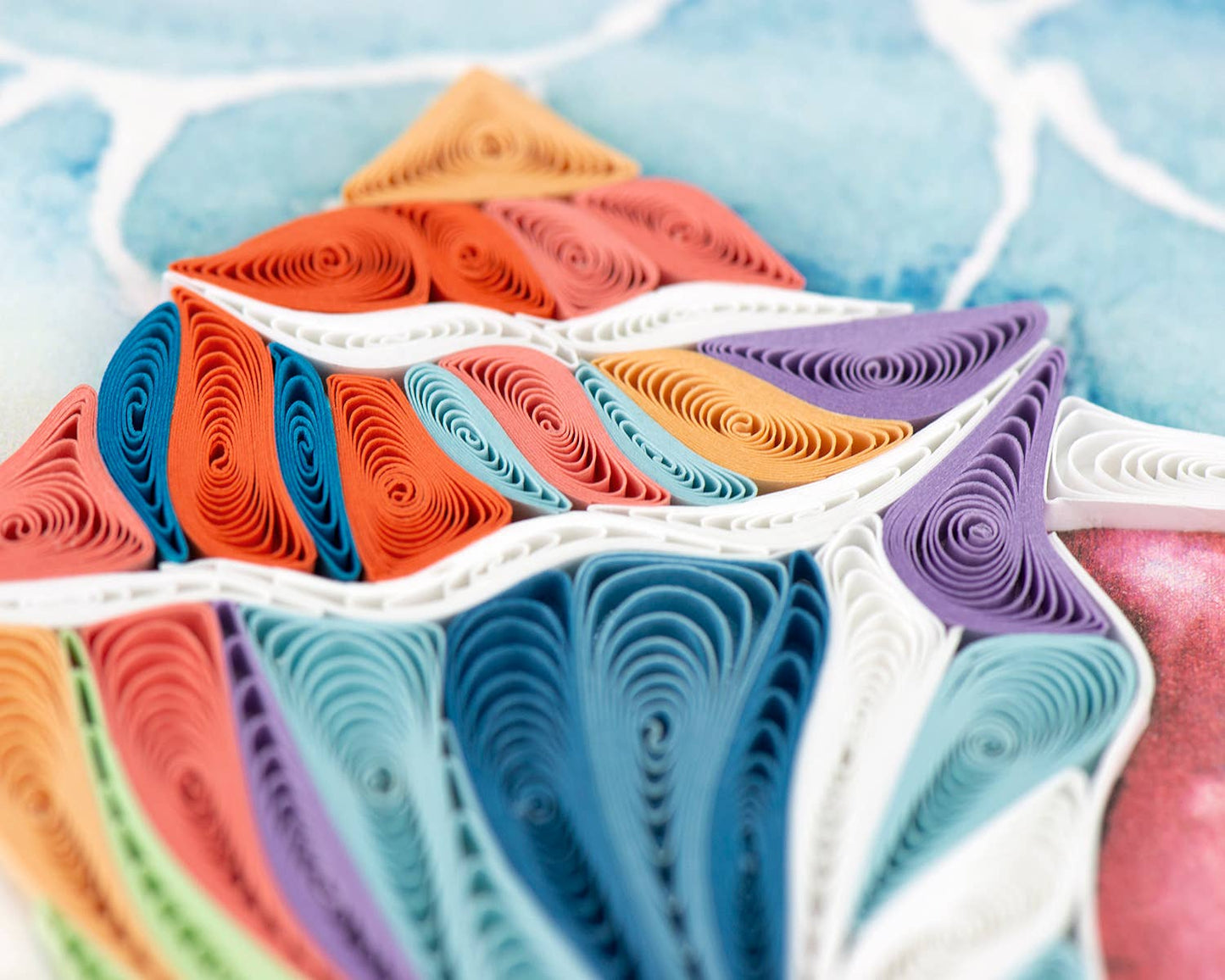 Quilled Rainbow Conch Shell card from stationery store, featuring vibrant colors and intricate design.
