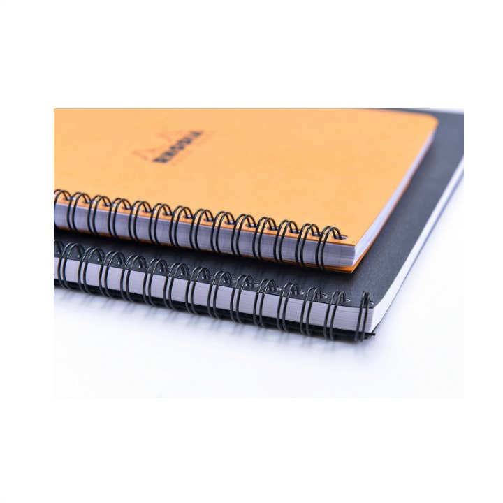 Rhodia Spiral 4 Color Book notebooks with black and orange covers, featuring double wire-binding and micro-perforated pages, stationery store