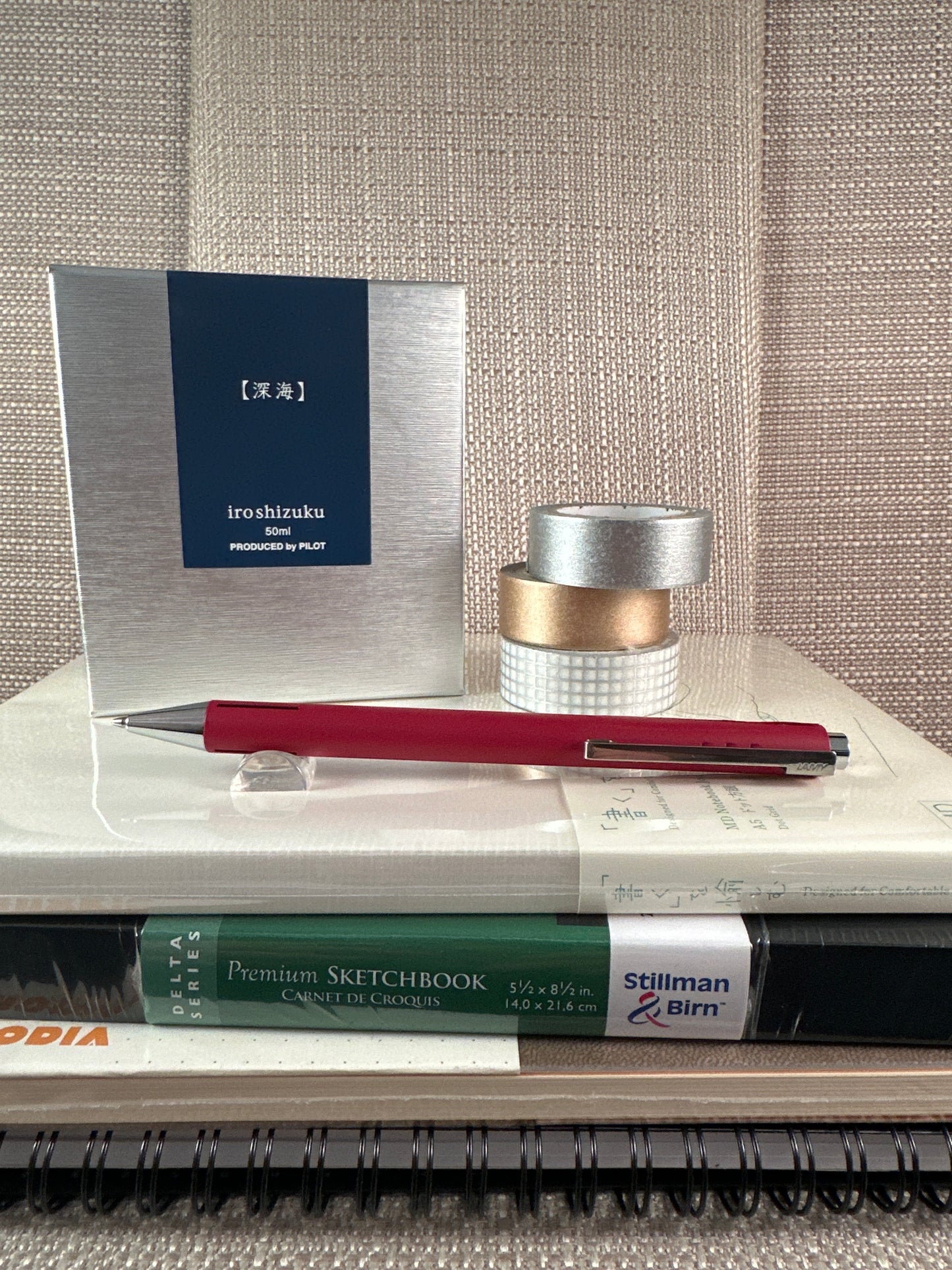 LAMY Econ Ballpoint Pen on notebooks with stationery items at a stationery store display.