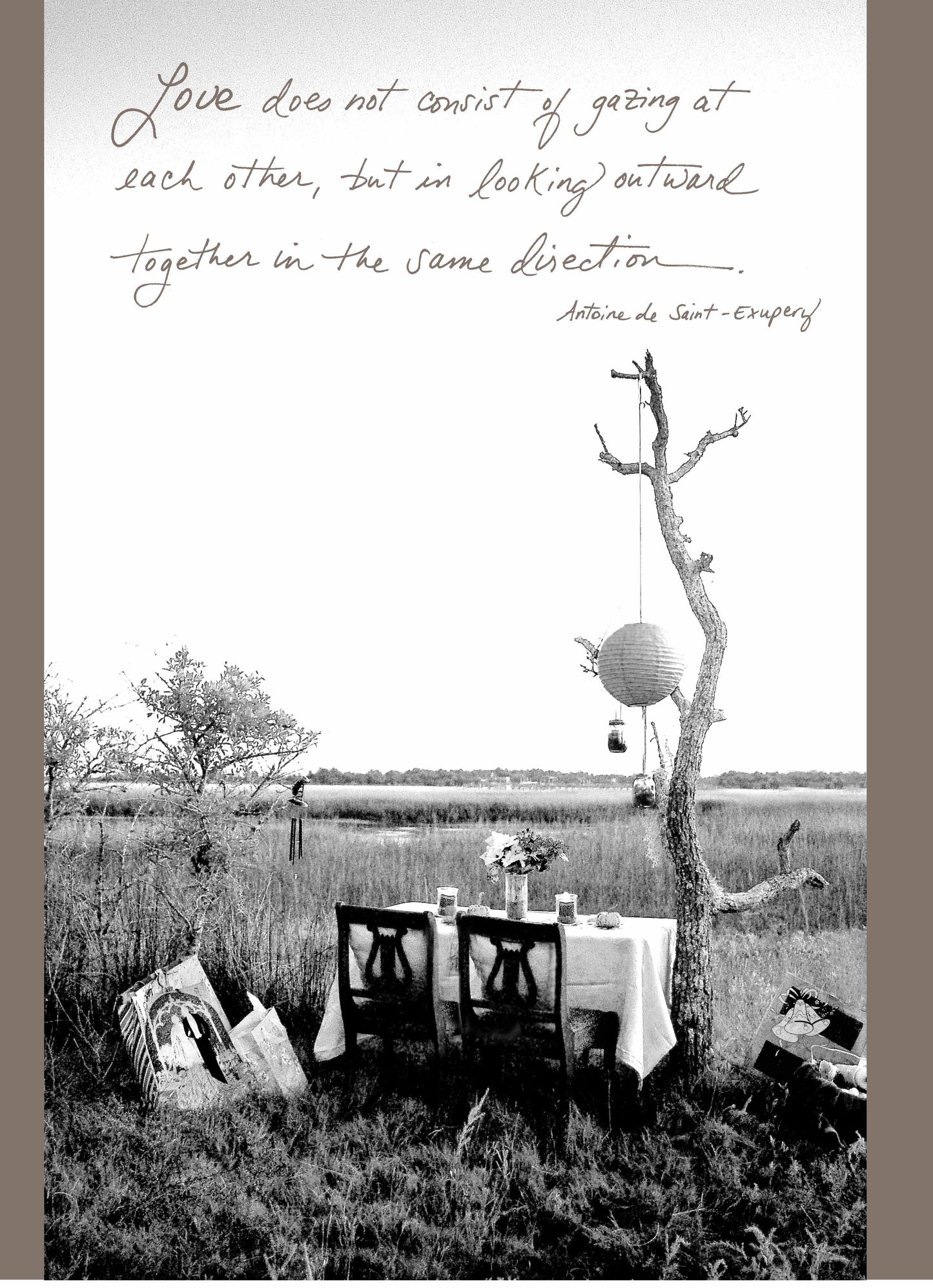 Black and white outdoor dining image with quote by Antoine de Saint-Exupéry on love; stationery store greeting card design.