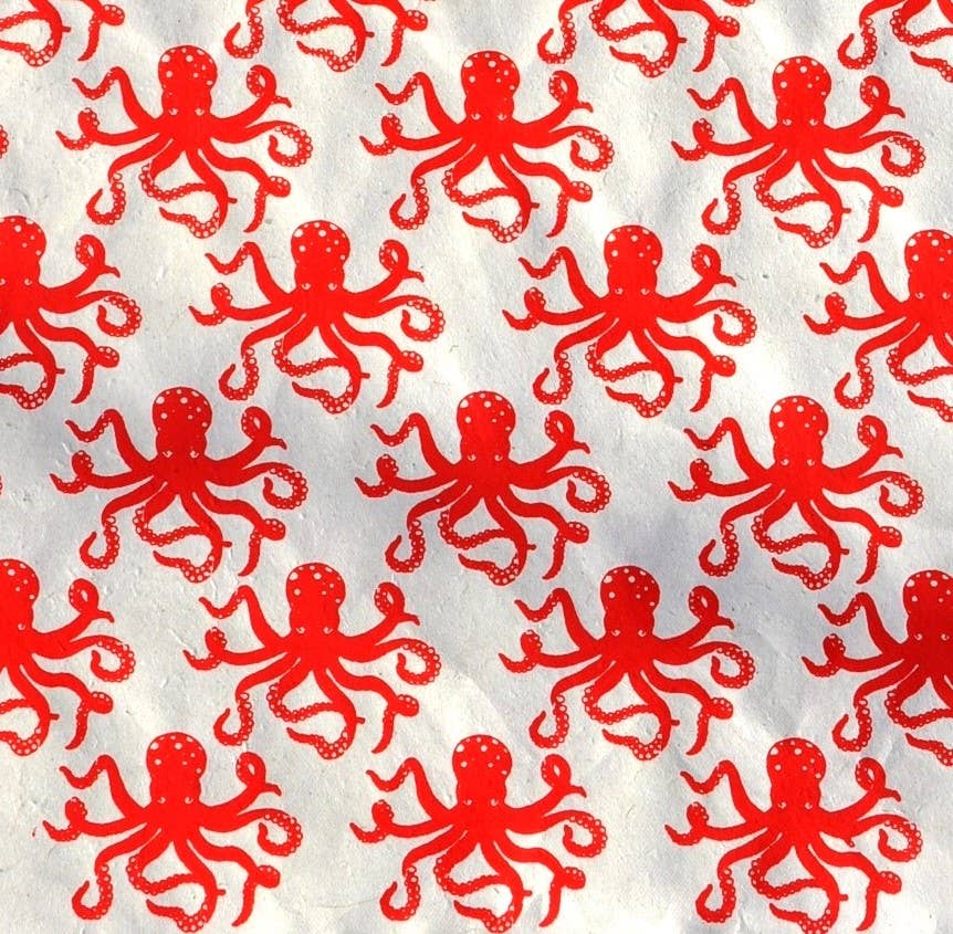 Vibrant red octopus pattern on cream 30x20 wrap, eco-friendly paper from Kathmandu for stationery stores. Sustainable Giftsland product.