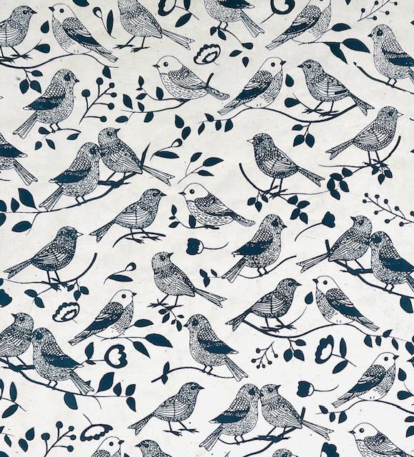 Handmade black bird pattern on light brown paper, crafted from Himalayan Daphne bark, perfect for stationery store needs.