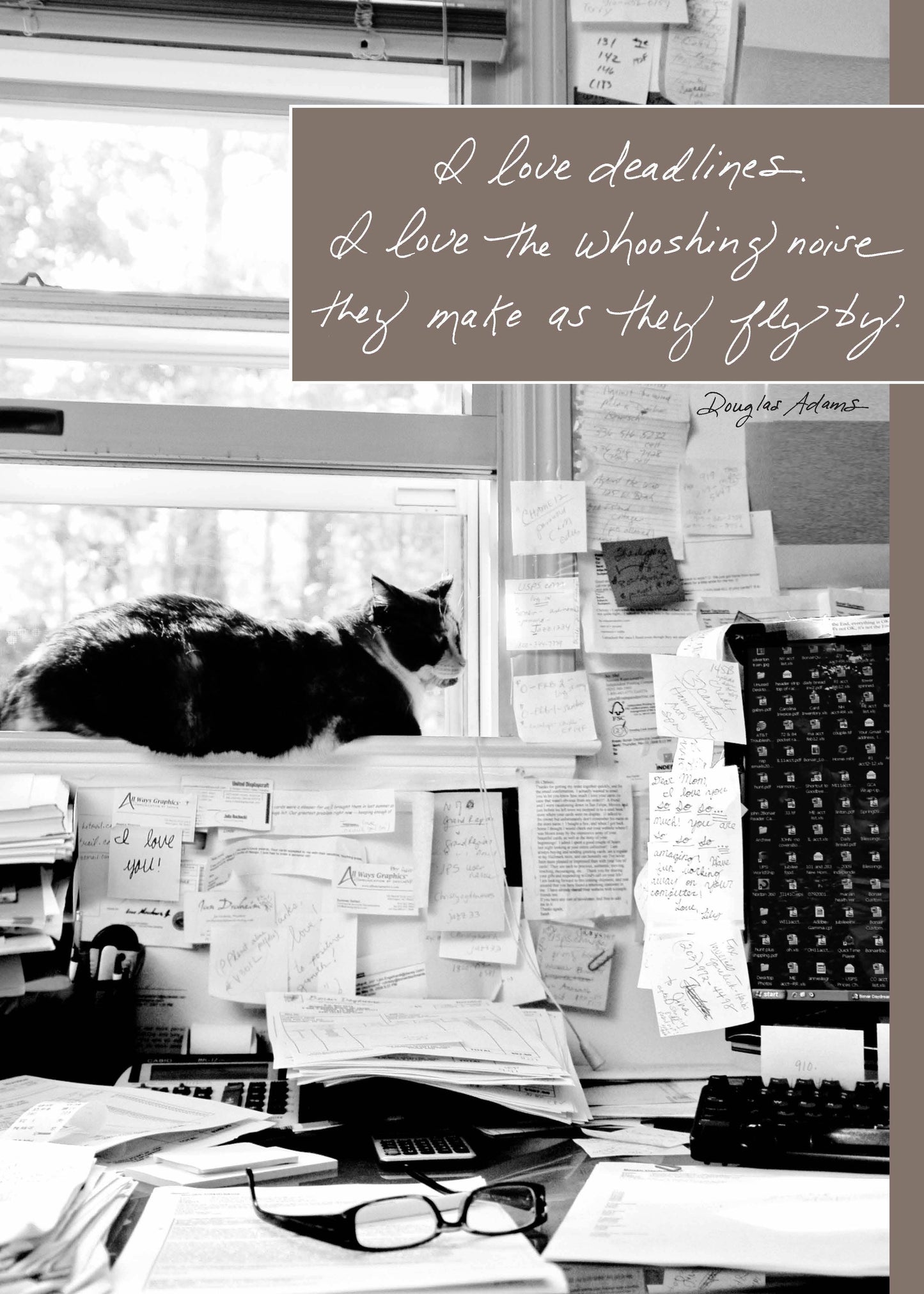 Douglas Adams quote on desk scene with cat, "I Love Deadlines and the Swooshing Noise." Available at stationery store.