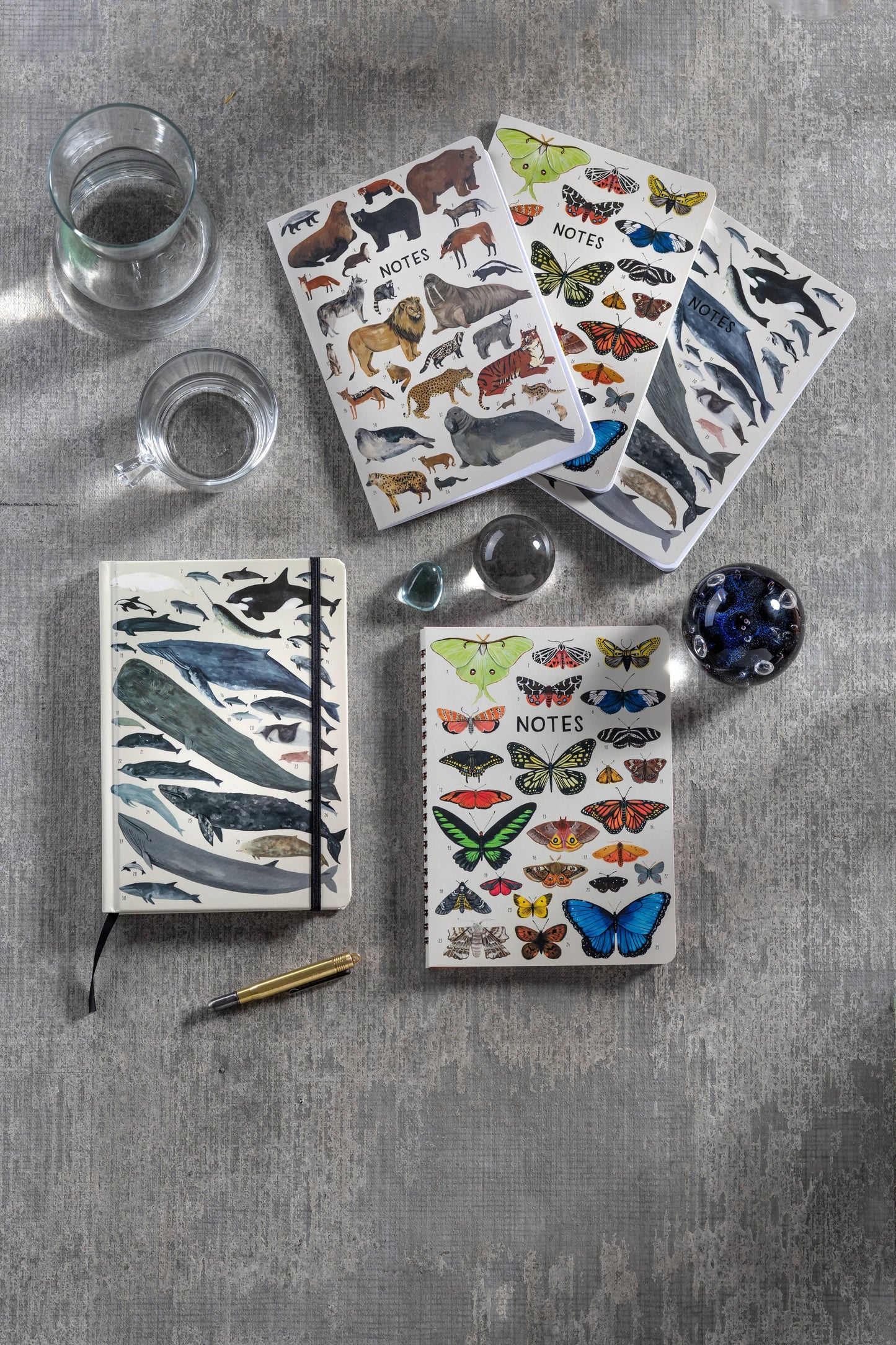 Orders of the Animals High Note 3-Pack Notebook Set on a table, featuring animal designs by Kelsey Oseid, available at stationery store.