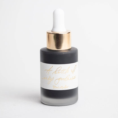 Moon Grey Calligraphy Ink in recyclable glass bottle with gold foiled label, perfect for stationery store enthusiasts.