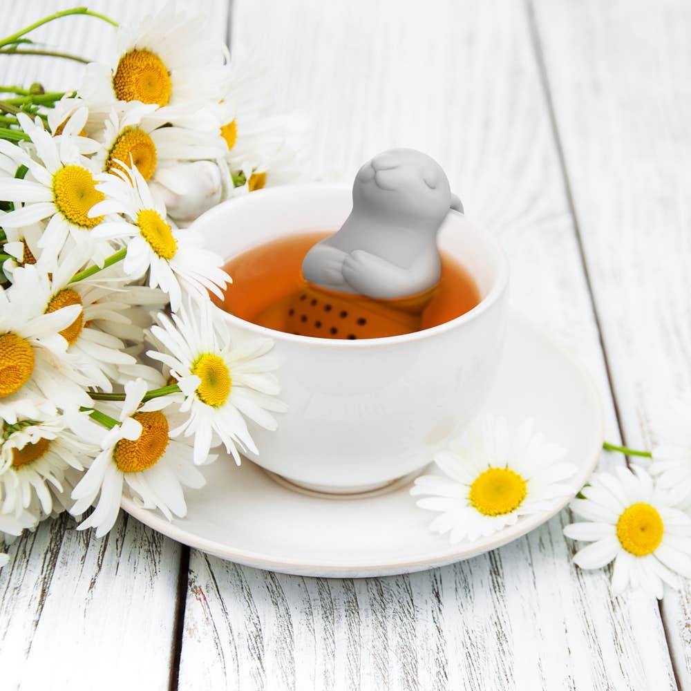 Alt Tag: Brew Bunny Rabbit Tea Infuser floating in cup, surrounded by daisies, ideal for loose leaf tea, available at stationery store.