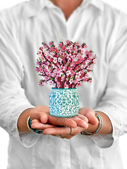 Mini Cherry Blossom Pop-up Greeting Card held in hands, perfect for stationery store as a year-round blossom display.