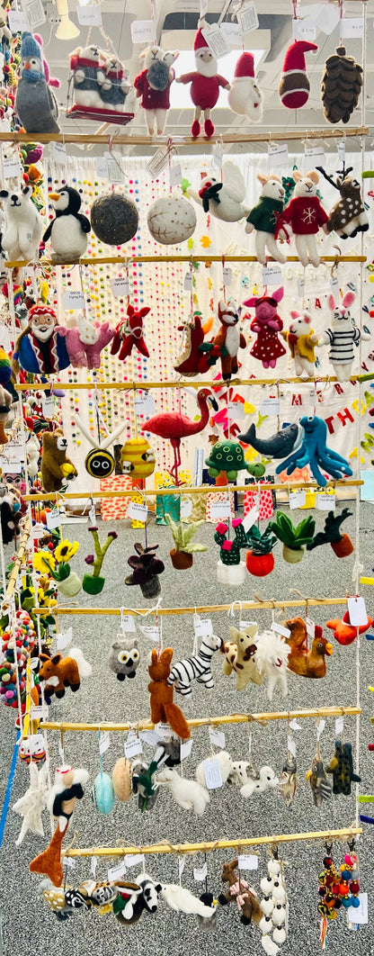 Colorful display of various ornaments, including animals and festive figures, at a stationery store, showcasing decorative home accents.