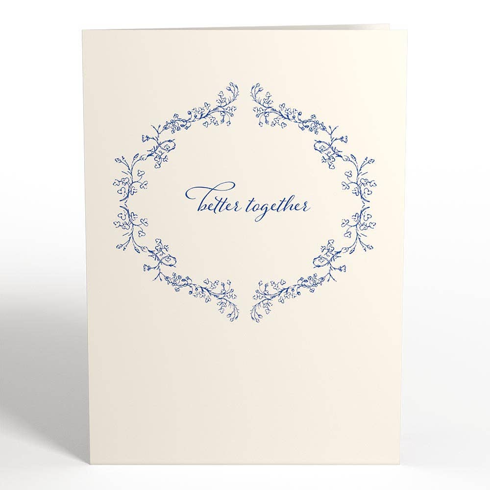 Better Together Mr & Mrs 5x7 pop-up wedding card with floral wreath design, available at stationery store. Ideal for weddings or home decor.