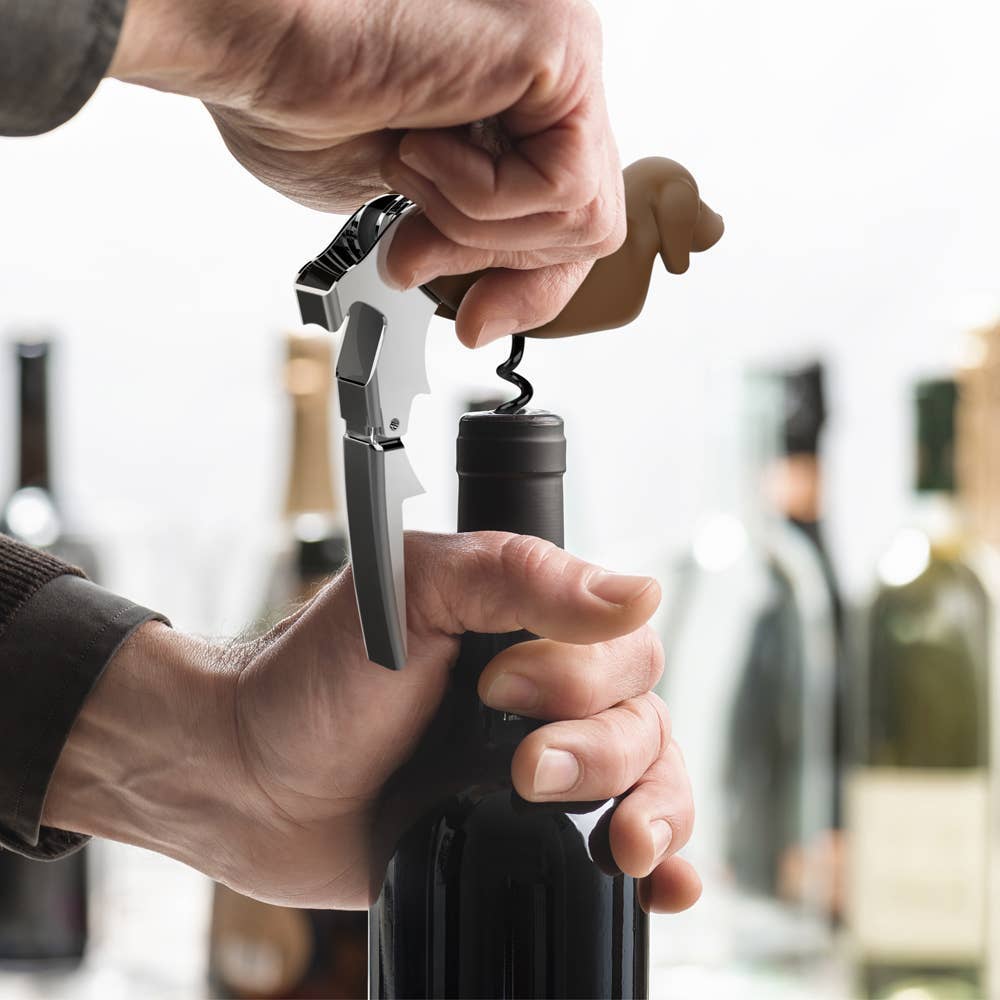 Winer Dog corkscrew with bottle opener and foil cutter in use, perfect for stationery store wine accessory collection.