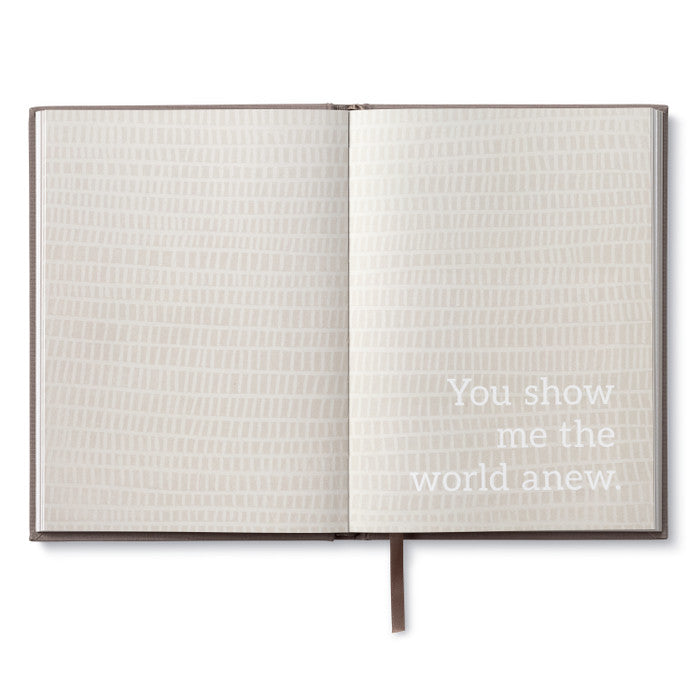 Alt Tag: Open book titled 'In This Moment' with text 'You show me the world anew' available at stationery store