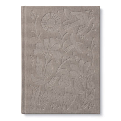 Embossed cover of 'In This Moment' book, a unique addition to our stationery store collection, featuring detailed floral designs.