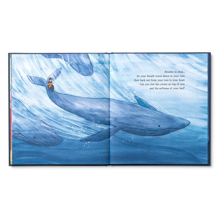 Book 'One More Book Before Bed' open to a page with illustrations of whales, available at a stationery store.