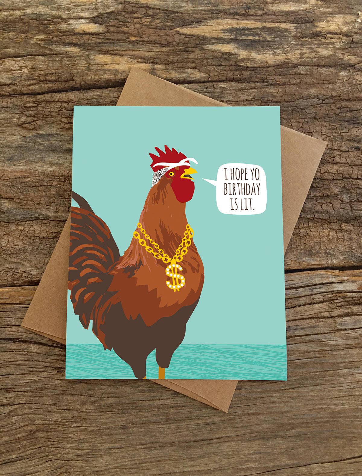 Lit Rooster Birthday Card on rustic background, blank A2 size, paired with recycled kraft envelope; stationery store eco-friendly option.