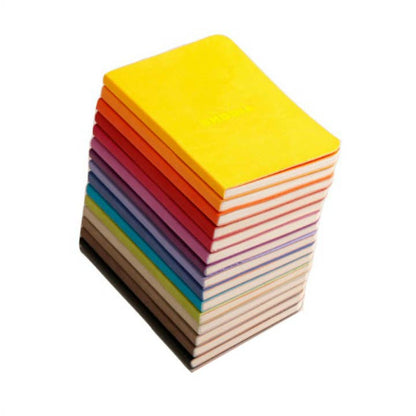 Stack of colorful Rhodiarama Softcover Journals (A5) available at stationery store. Features vegan leather cover and fountain pen-friendly paper.