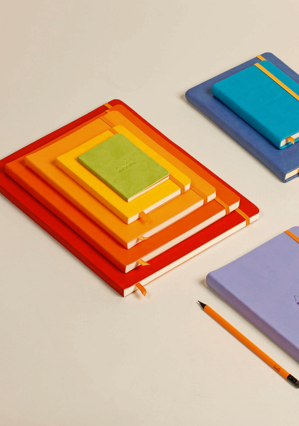 Colorful Rhodiarama Softcover Journals in various sizes, featuring soft vegan leather covers, perfect for stationery store display.