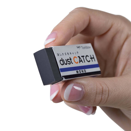 Person holding MONO Dust Catch Eraser with tacky polymer design, ideal for stationery stores to keep illustrations clean and residue-free.