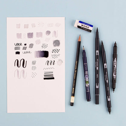 Tombow Drawing Set with brush pens, pencil, eraser, and doodles on paper from a stationery store