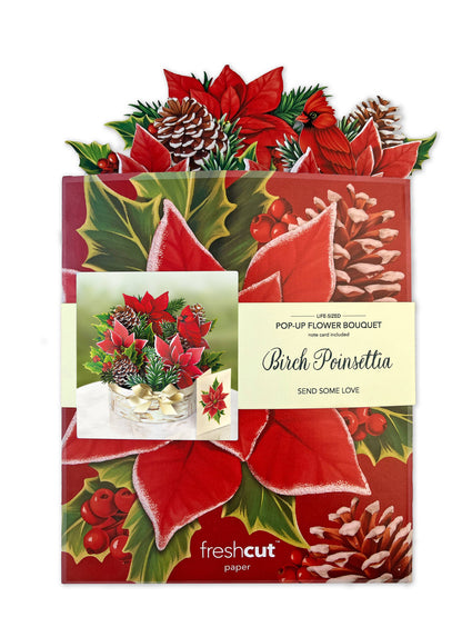 Birch Poinsettia pop-up greeting card featuring pinecones, poinsettia leaves, and cardinal, available at stationery store