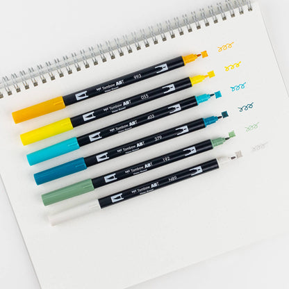 Dual Brush Pen Art Markers in Lemon Squeezy set on paper, demonstrating color strokes. Perfect for artists in stationery store.