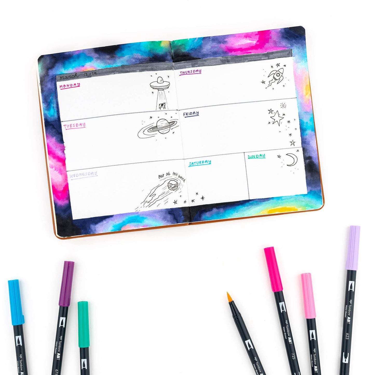 Alt Tag: Dual Brush Pen Art Markers in Galaxy colors used in a planner layout, ideal for artists and crafters. Available at stationery stores.