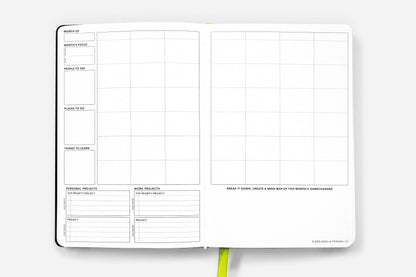 Open pages of the Daily Planner - Undated - Cosmic Blue, featuring grids and planning sections, available at the stationery store.