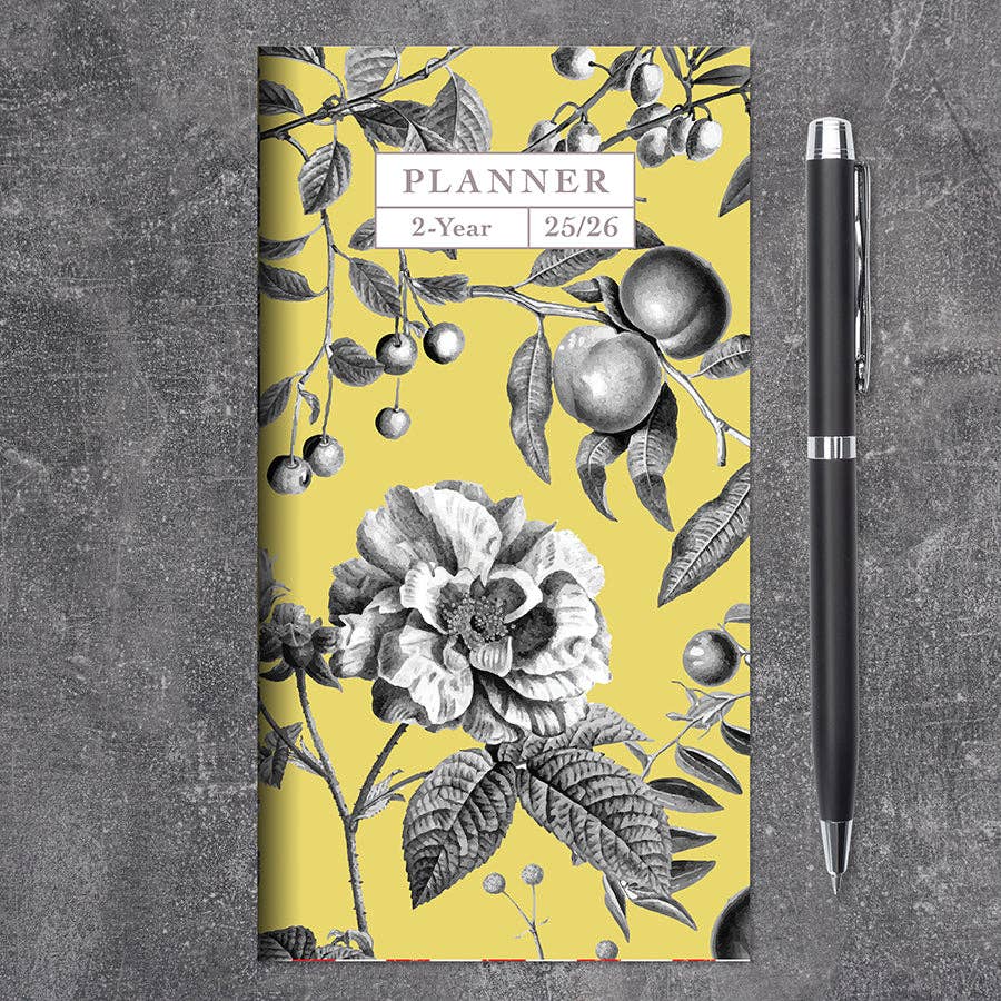 2025-2026 Yellow Botanical Small Monthly Pocket Planner with floral cover on gray background at stationery store.