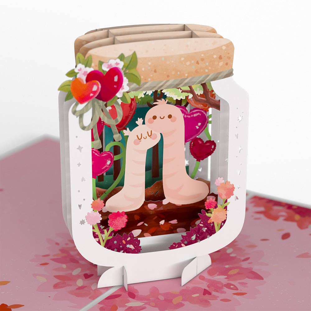 Pop-up card featuring two cute worms in love inside a jar with heart decorations, perfect for Valentine's Day. Available at stationery stores.