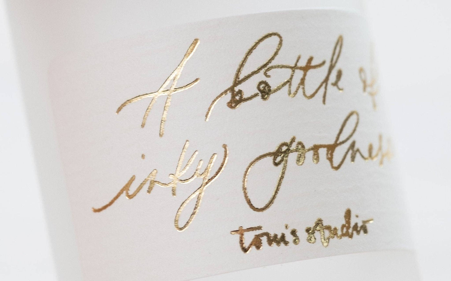 Close-up of gold foiled calligraphy on Moon Grey ink bottle label from UK stationery store.