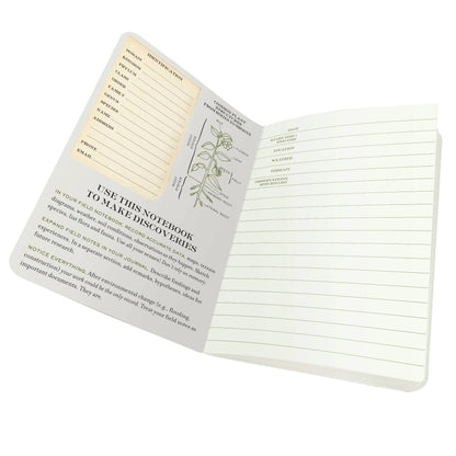 Botany Naturalist's Notebook open with charts, ideal for discoveries, from stationery store. Lightweight and compact design.