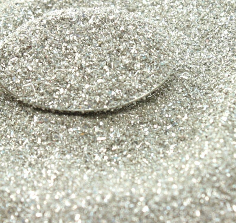 Silver Sparkly German Glass Glitter 90 Grit, ideal for stationery store projects, shown in close-up with shimmering fine texture.