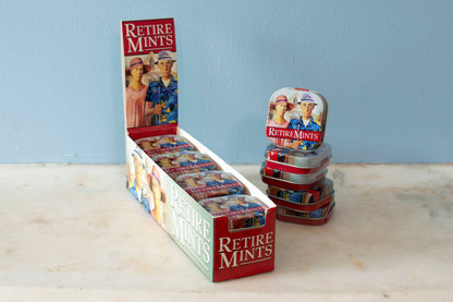 Retiremints in a peppermint tin, "Goodbye tension, hello pension!" display at a stationery store.