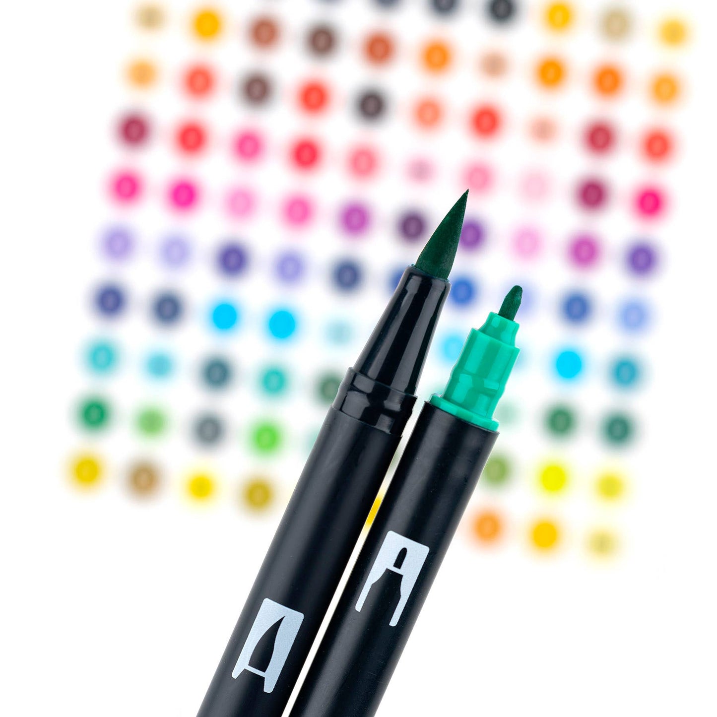 Close-up of Dual Brush Pen Art Markers in Galaxy set, showcasing flexible brush and fine tips with colorful background at stationery store.