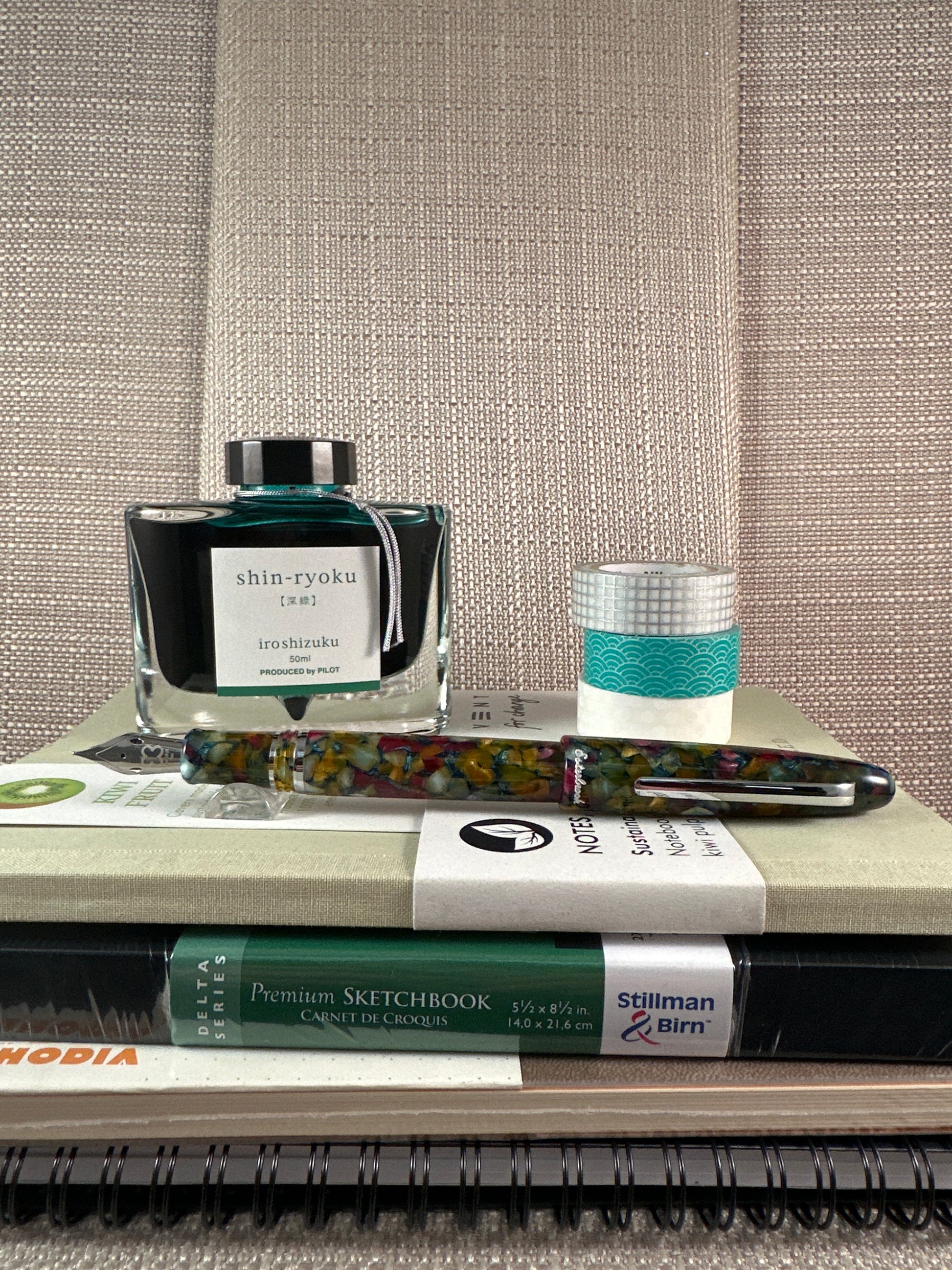 Esterbrook "Estie" Fountain Pen with ink bottle and sketchbooks on a stationery store display.