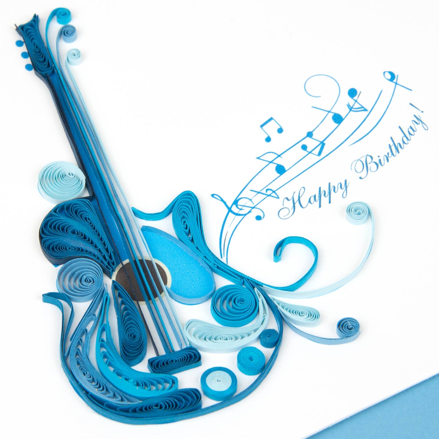 Quilled Birthday Guitar card with blue guitar and musical notes, perfect for musical friends. Available at stationery store.