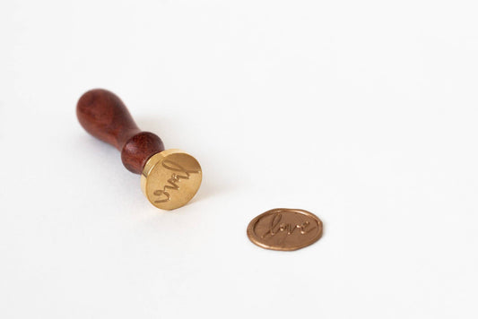 Hand lettered Love Wax Seal Stamp with rosewood handle from stationery store, featuring unique brass etching by Modern Legacy Paper Company.