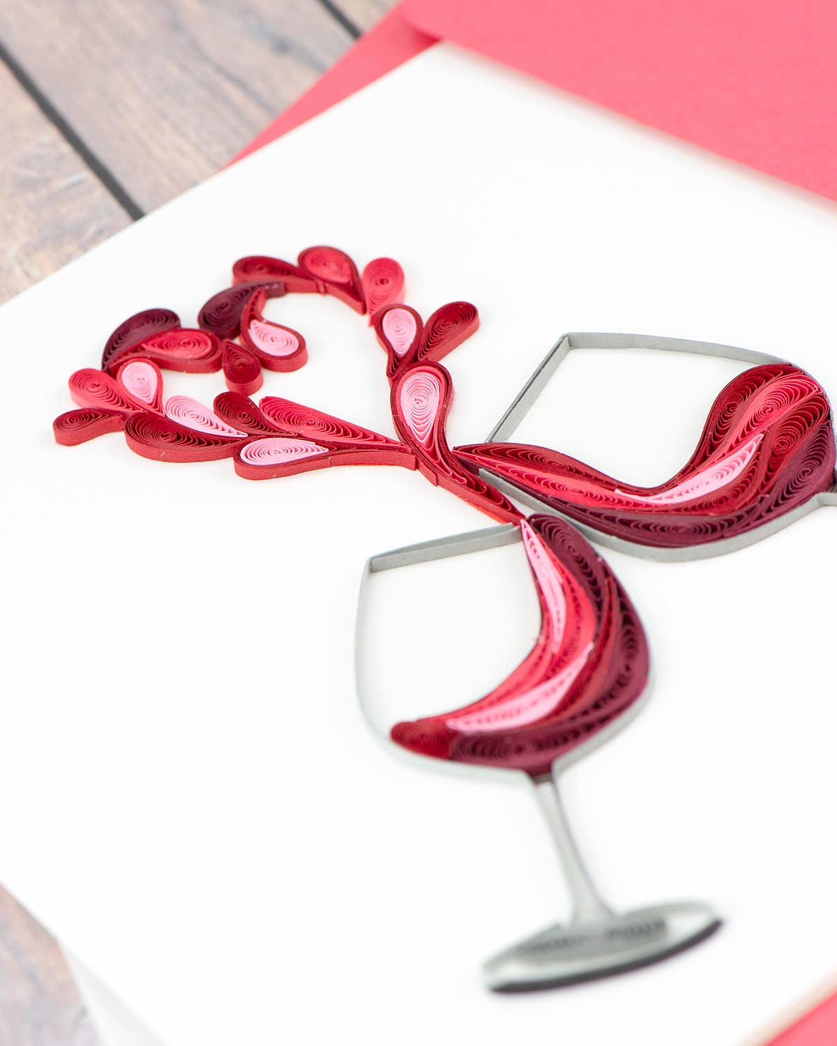 Quilled greeting card with two wine glasses making a heart, "A Toast to Love" design from stationery store.