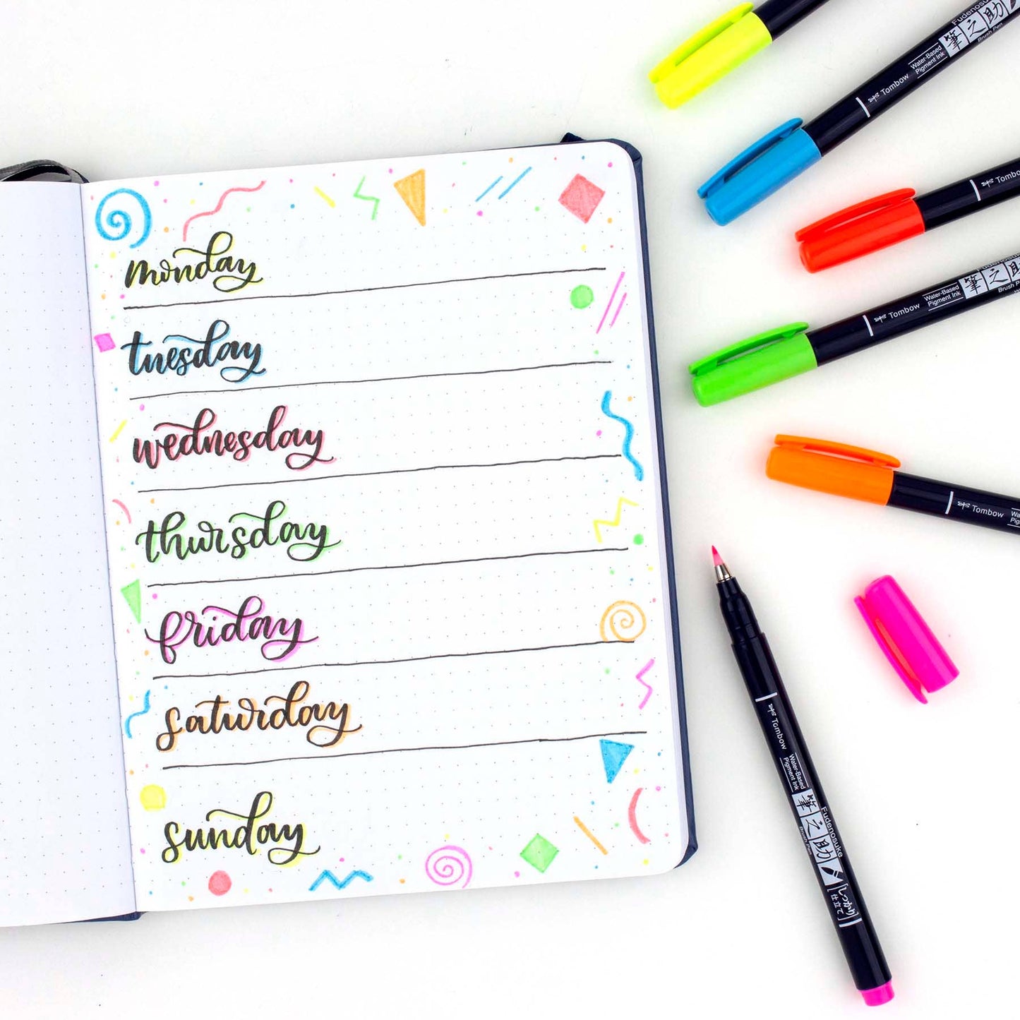 Alt Tag: Fudenosuke Calligraphy Brush Pen used for creative weekly planner in vibrant colors, available at stationery store.