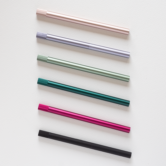 Lumos Pro refillable multi-tip pens in matte black, rose gold, sage, and more lined up. Perfect stationery store addition.