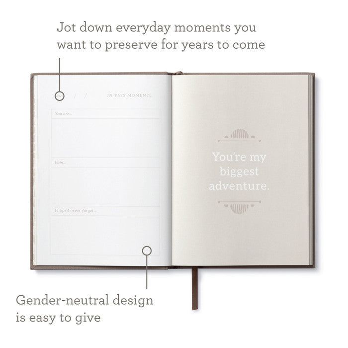 Open "In This Moment" book from stationery store, featuring gender-neutral design for jotting down everyday moments to preserve.