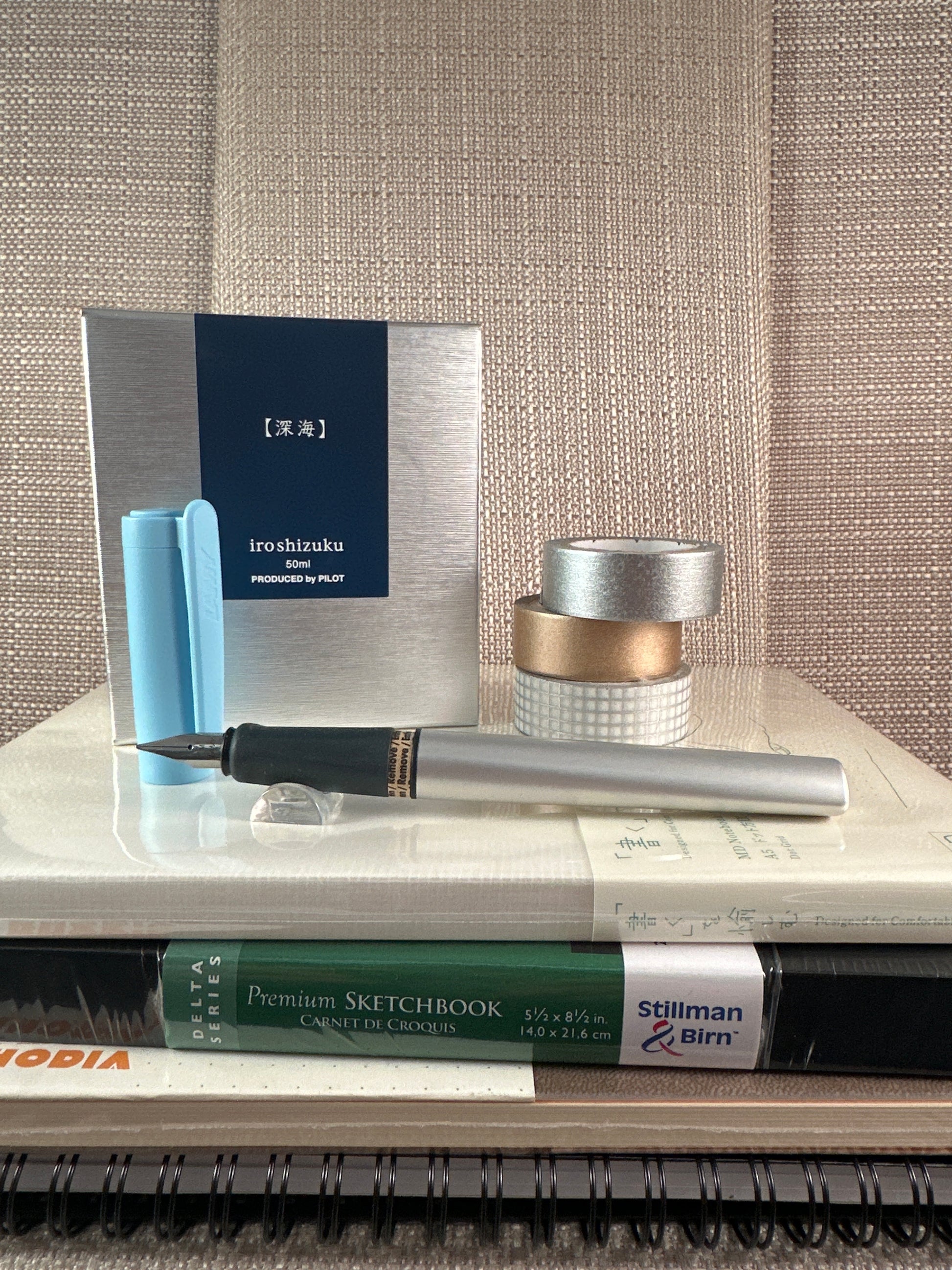 LAMY Nexx Fountain Pen displayed with sketchbooks and art supplies from stationery store.