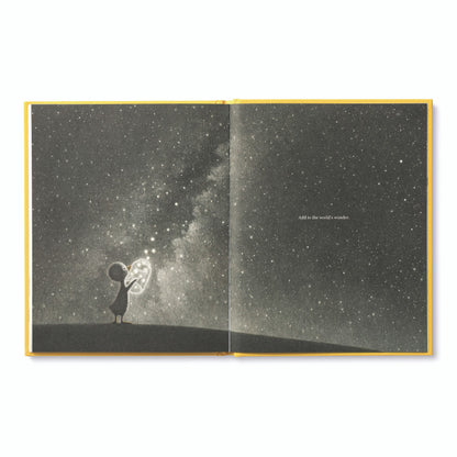 Open page of 'Finding Muchness' book featuring a celestial illustration, available at a stationery store.