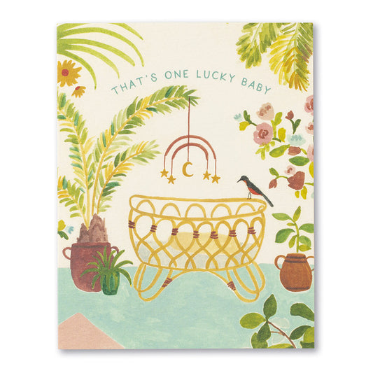 Love Muchly Baby card featuring 'That's One Lucky Baby' phrase with a crib and plants, available at a stationery store.