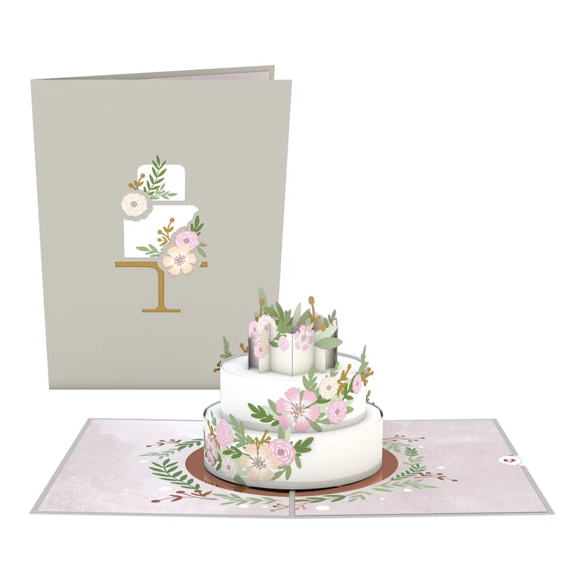 Wedding Cake Pop Up Card from stationery store. Whimsical 3D design features floral decorations, perfect for weddings or bridal party proposals.