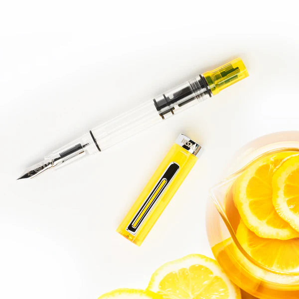 TWSBI ECO Transparent Yellow Fountain Pen with vibrant lemon slices, ideal for stationery store enthusiasts.