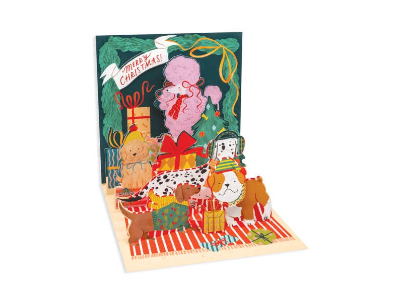 Puppy Gift Exchange Christmas Pop-Up Card with Santa, from a stationery store, featuring colorful artwork and gold foil accents.