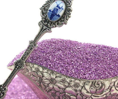 Close-up of Lilac Sparkly German Glass Glitter, 90 grit, showcasing decorative antique silver spoon, ideal for stationery store crafts.