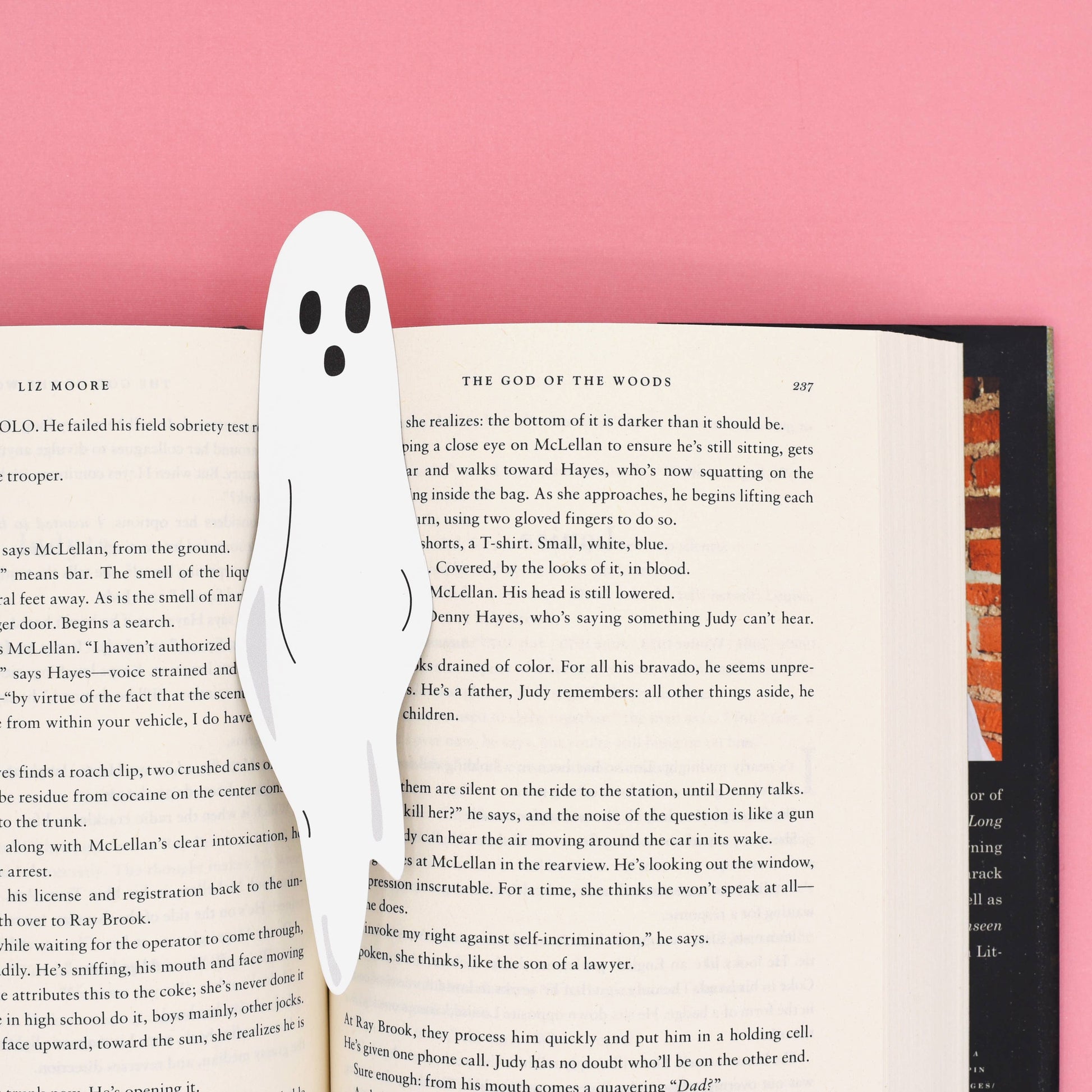 A ghost bookmark sticking out of a book, double-sided UV print on sturdy paper stock. Available at stationery store.