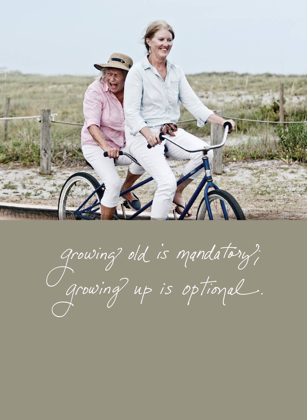 Women enjoying tandem bike ride, smiling, with text 'Growing Old Is Mandatory; Growing Up Is Optional,' birthday card from stationery store.